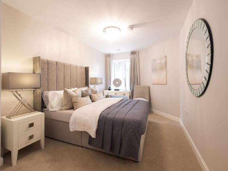 a bedroom with a bed and a mirror