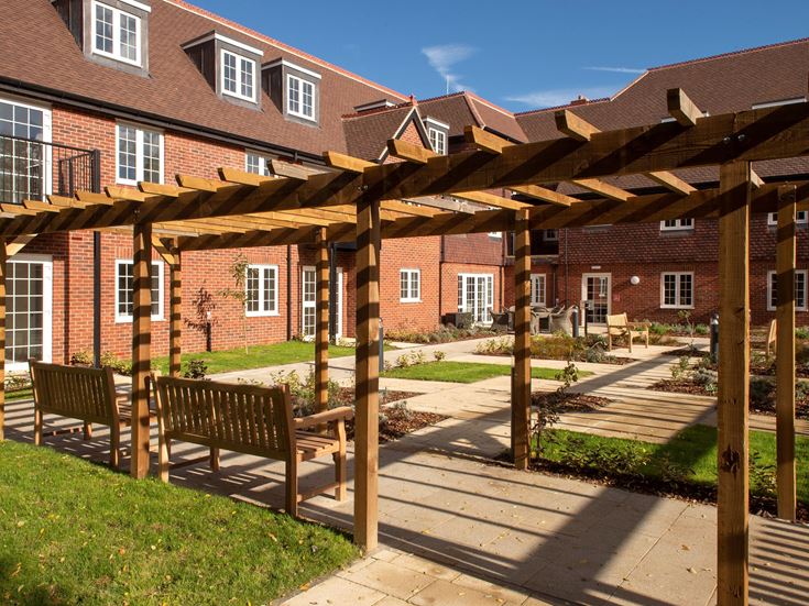 a wooden fence in front of a brick building