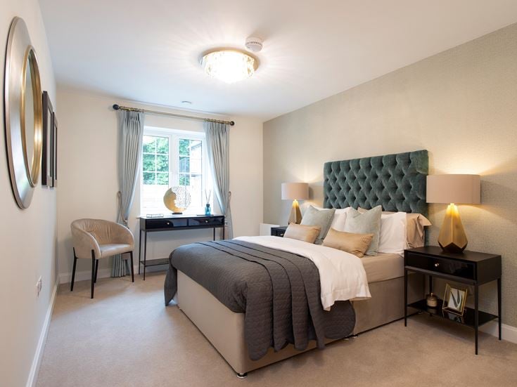 a bedroom with a bed and a desk