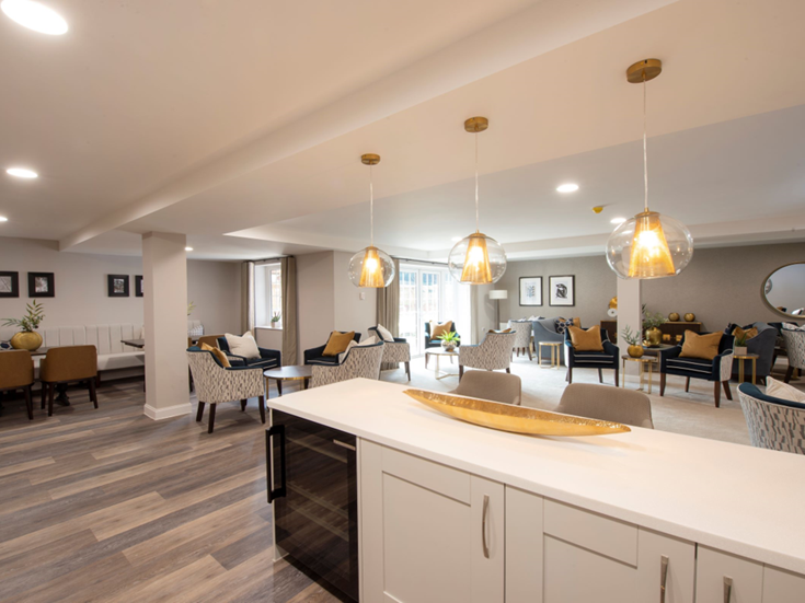 a large room with a bar and chairs