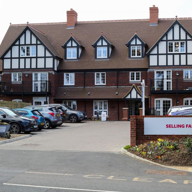 a building with cars parked in front