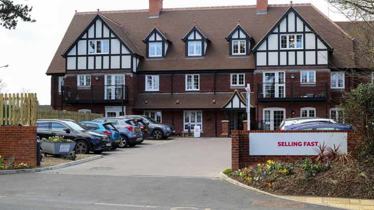 a building with cars parked in front