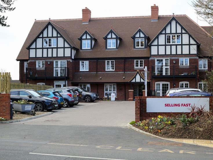 a building with cars parked in front