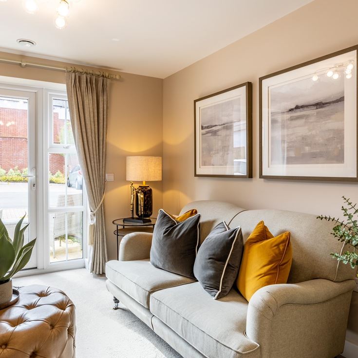 a living room with a couch and a lamp