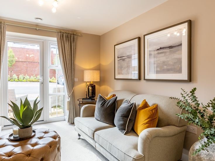 a living room with a couch and a lamp