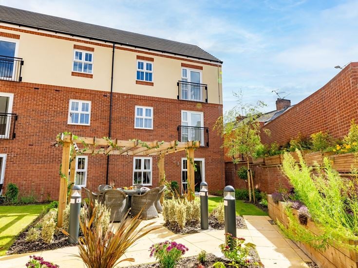 a brick building with a garden