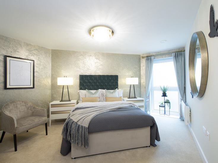 a bedroom with a bed and a chair
