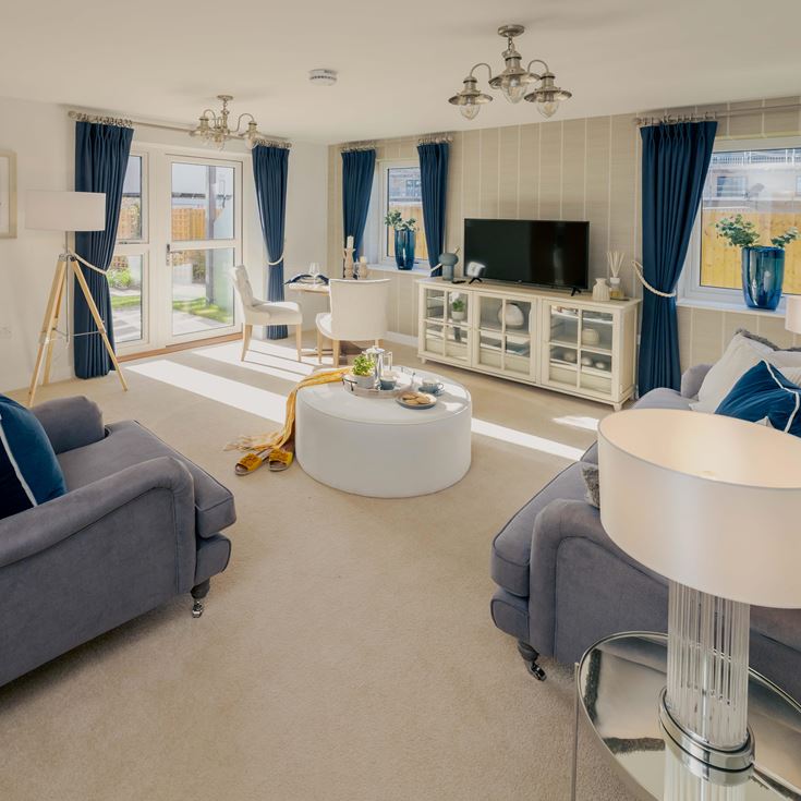 a living room with a blue couch and a white table