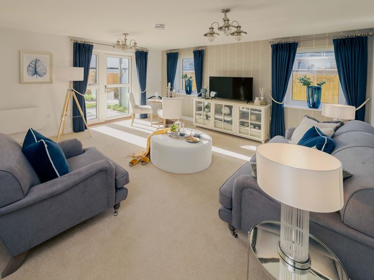 a living room with a blue couch and a white table