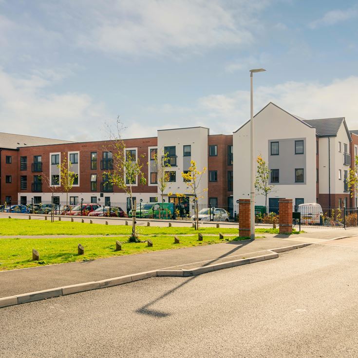 a street with buildings and a fence