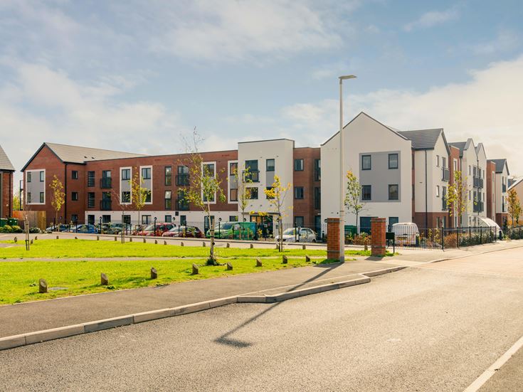 a street with buildings and a fence
