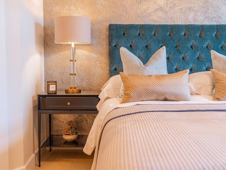 a bed with a lamp on the side