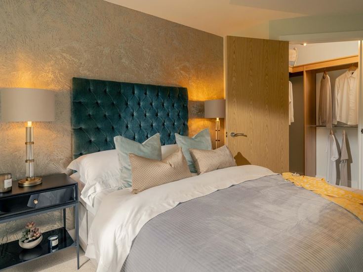 a hotel room with a bed and lamps
