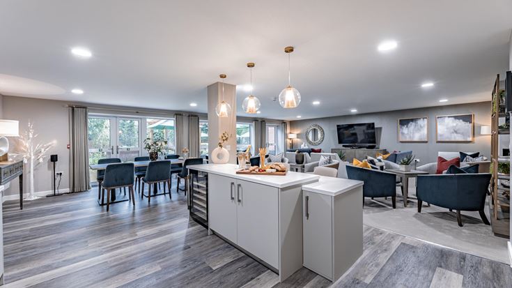 a large room with a wood floor and a large white counter with a large white counter and a