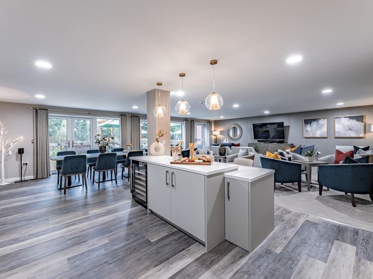 a large room with a wood floor and a large white counter with a large white counter and a