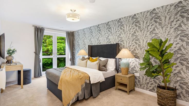 a bedroom with a large rock wall