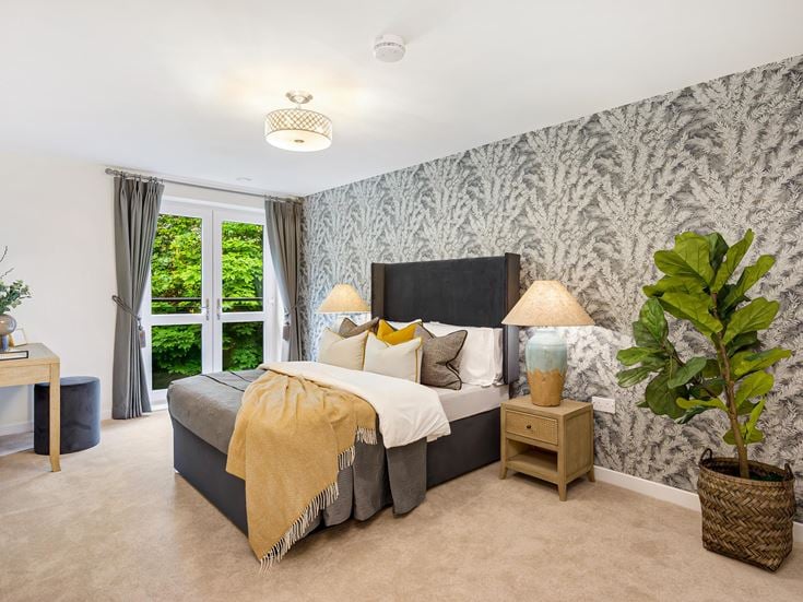 a bedroom with a large rock wall