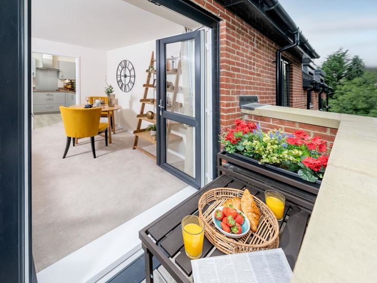 a patio with a table and chairs and a basket of food