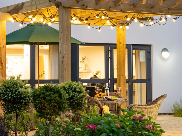 a patio with a table and chairs