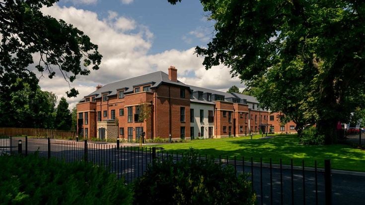 a large brick building with a fence around it
