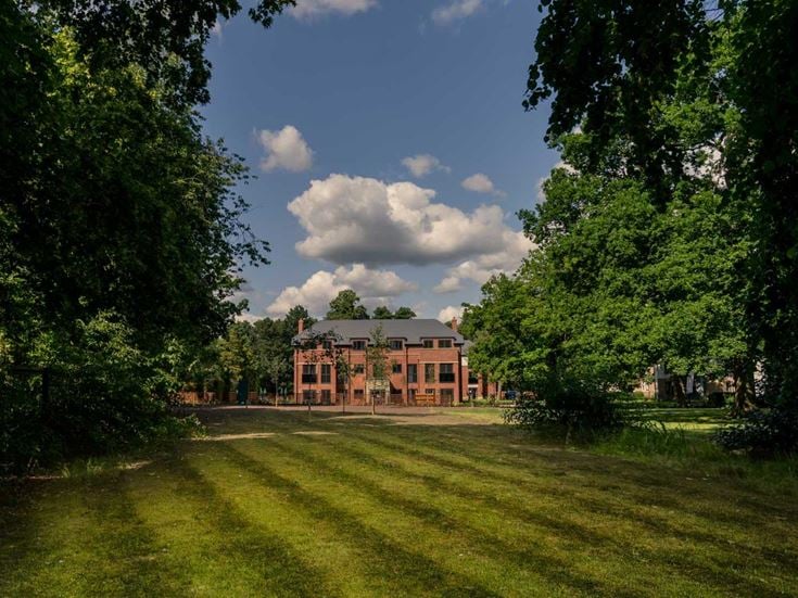 a large building with a lawn in front of it