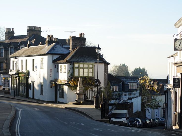 a street with cars and buildings along it