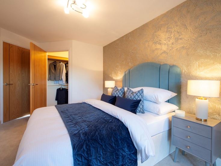 a bedroom with a bed and lamps