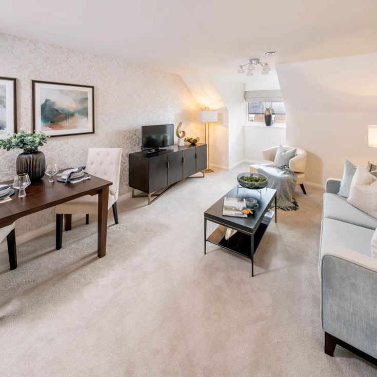 a living room with a table and chairs