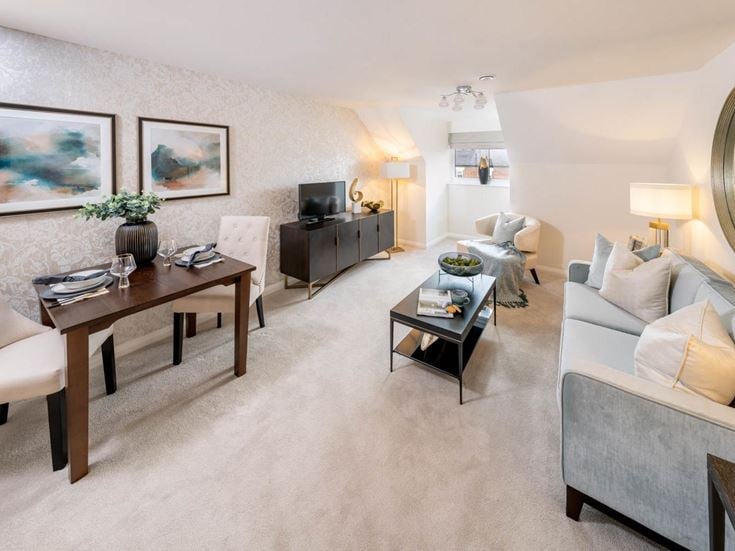 a living room with a table and chairs