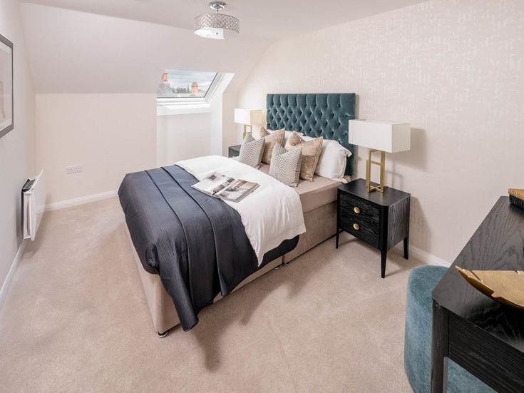 a bedroom with a bed and a desk