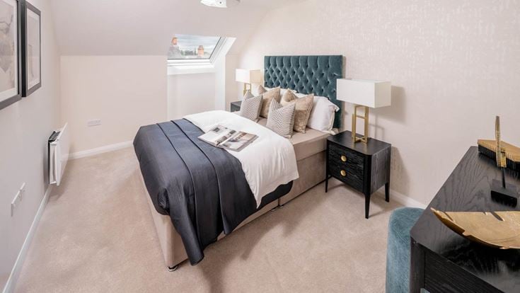 a bedroom with a bed and a desk