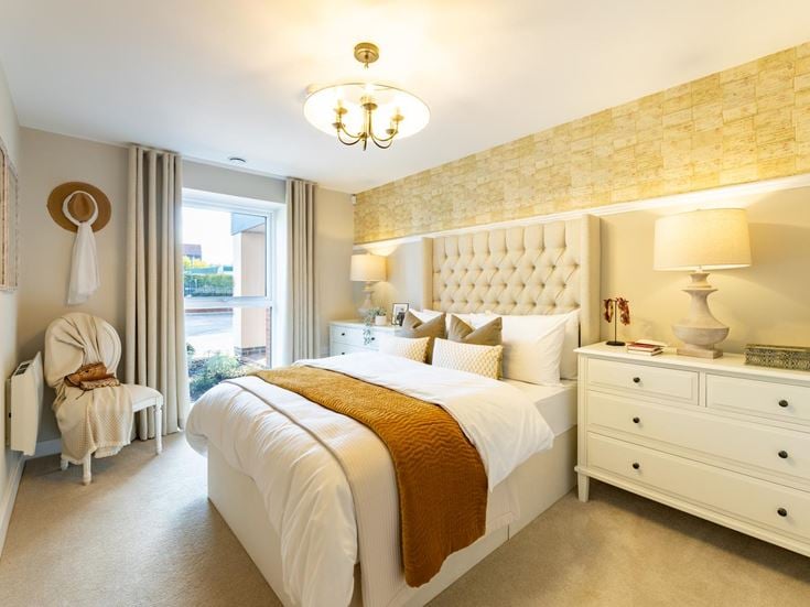 a bedroom with a bed and lamps