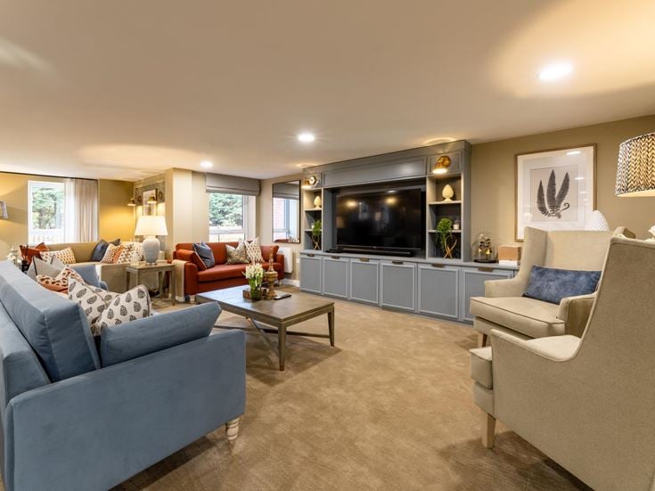 a living room with a tv and couches