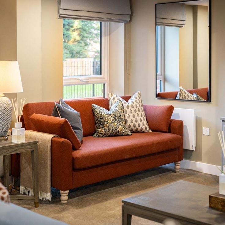 a living room with a red couch