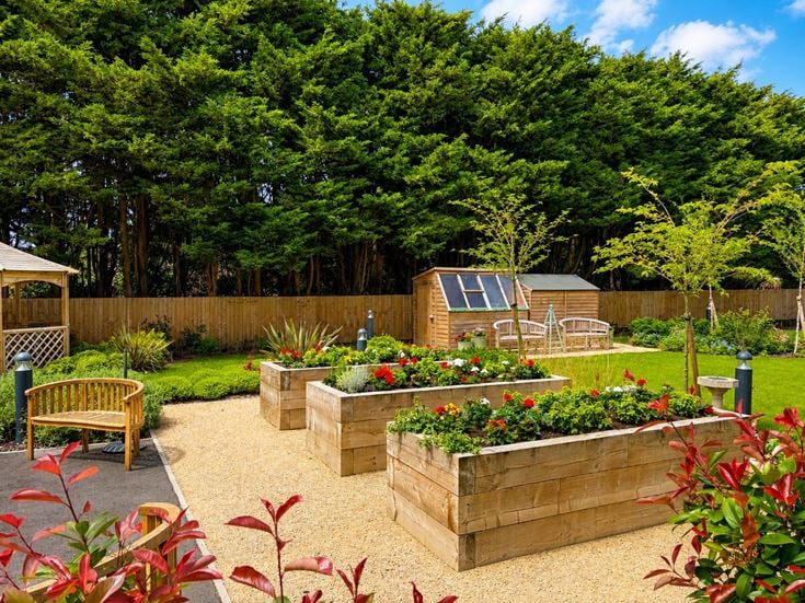 a backyard with a bench and a table and chairs