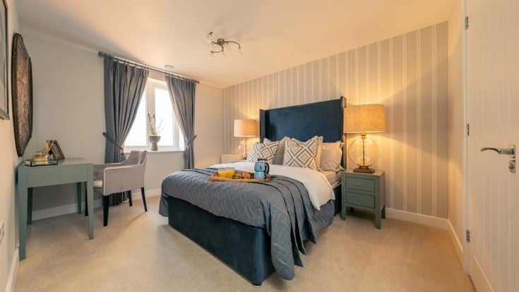 a bedroom with a bed and desk