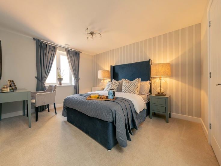a bedroom with a bed and desk