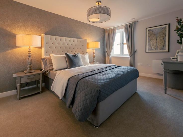 a bedroom with a bed and lamps