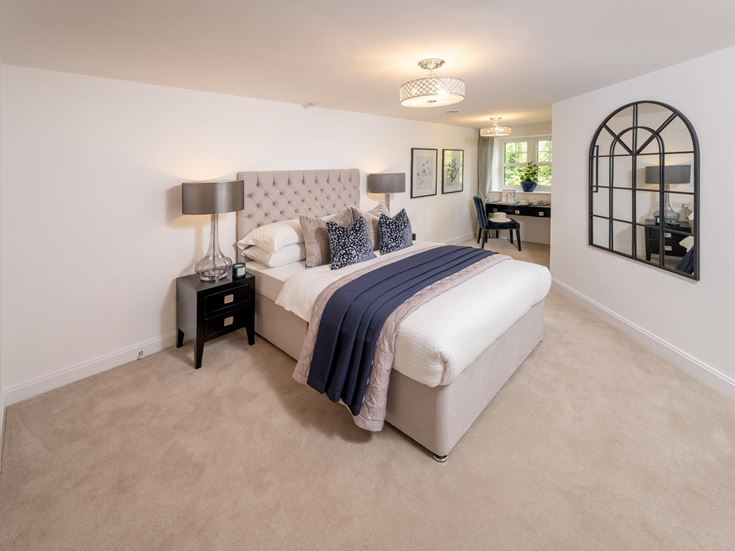 a bedroom with a bed and a desk