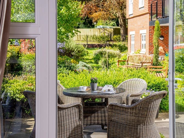 a patio with a table and chairs