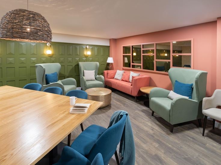 a room with a table chairs and a couch