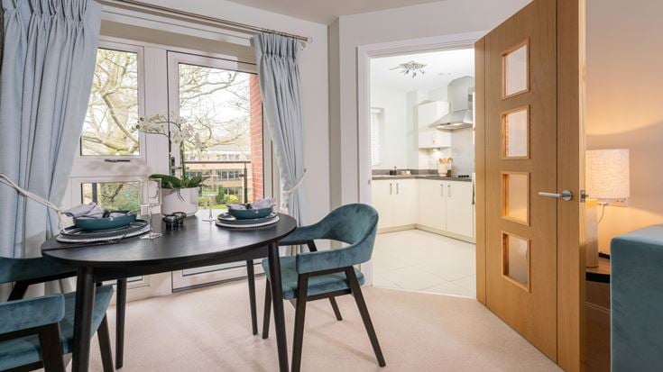 a dining room with a table and chairs