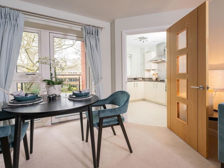 a dining room with a table and chairs