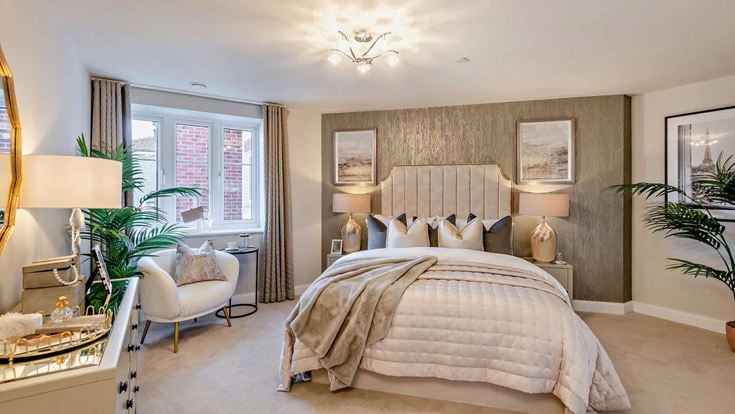 a bedroom with a bed and chairs