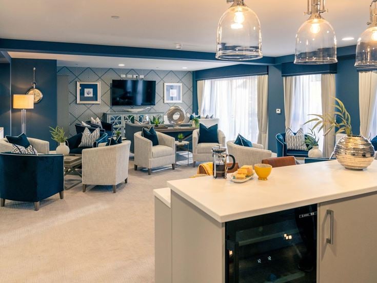 a living room with a kitchen and dining area