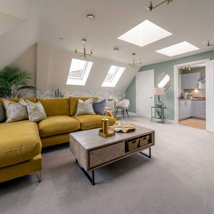 a room with yellow couches and a coffee table