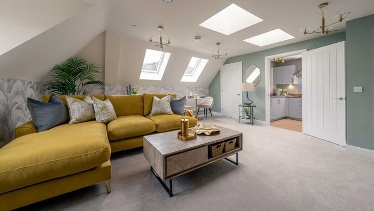 a room with yellow couches and a coffee table