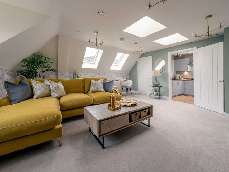 a room with yellow couches and a coffee table