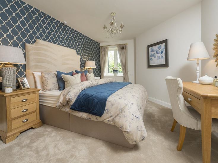 a bedroom with a bed and lamps