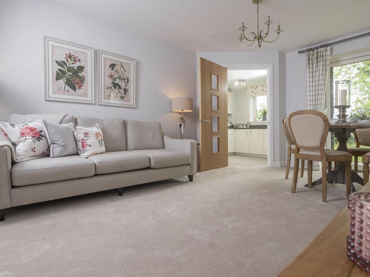 a living room with a couch and a dining table